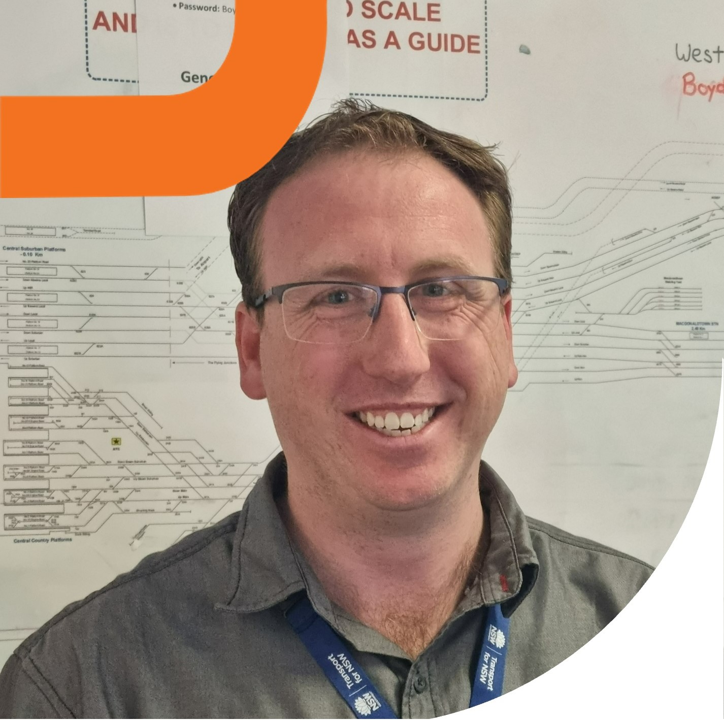 Smiling man in front of rail network chart