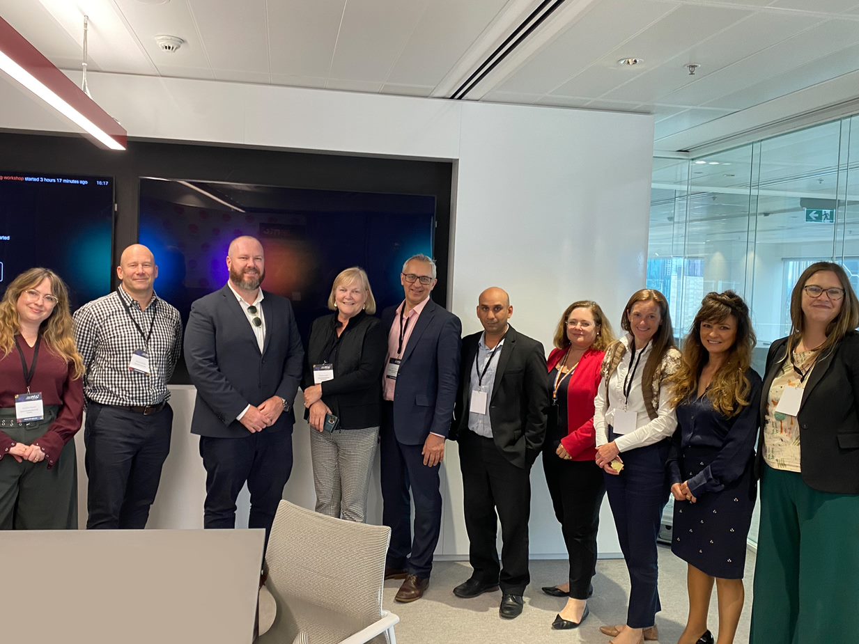 Group of men and women posing after a meeting