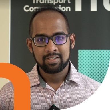 Man in front of NTC banner