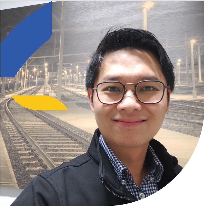 Man in front of train tracks