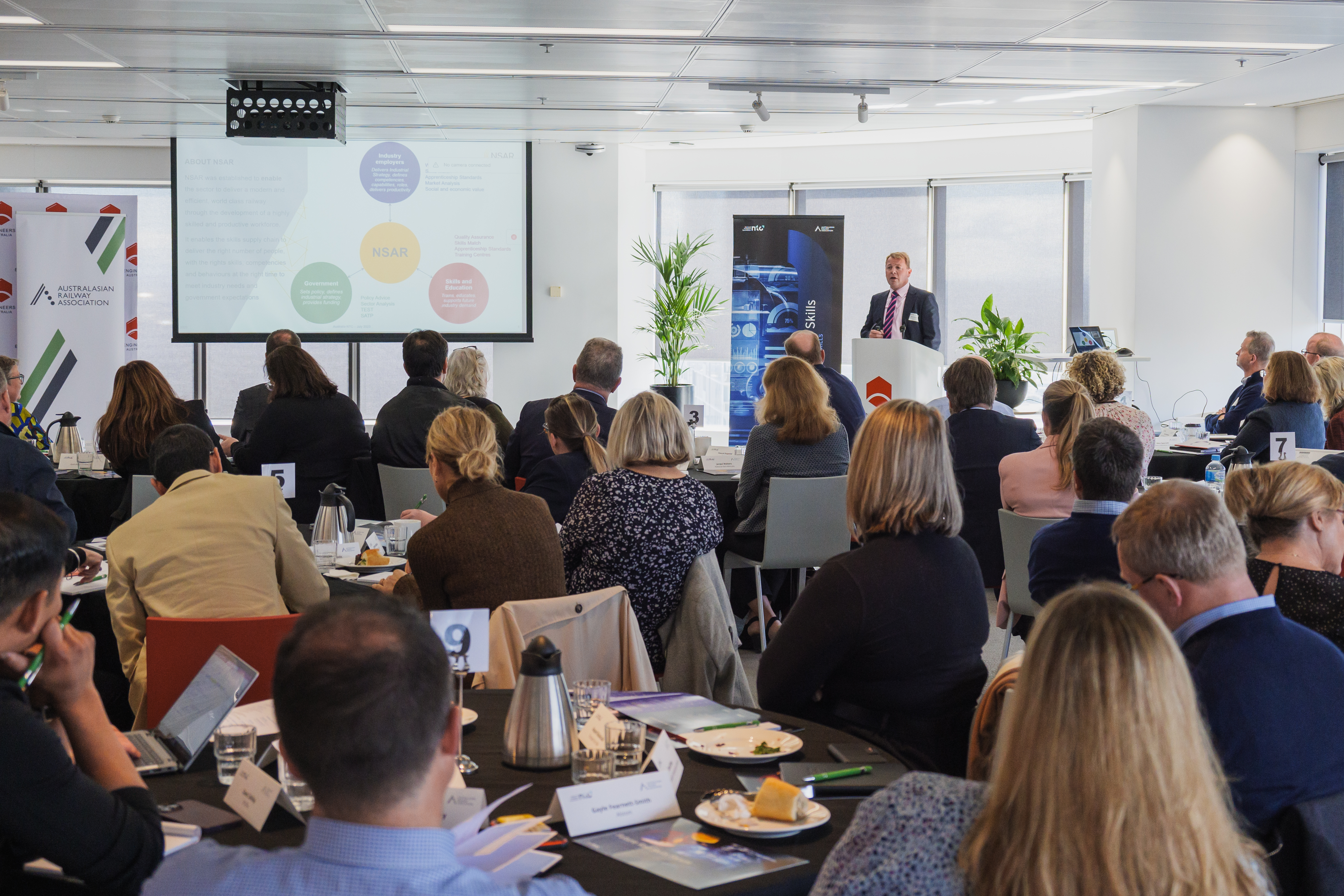 Men and women participating in a workshop at a rail skills forum