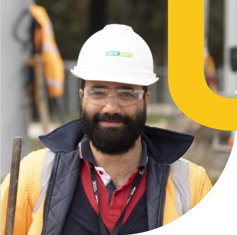 Engineer in hard hat on rail construction site.