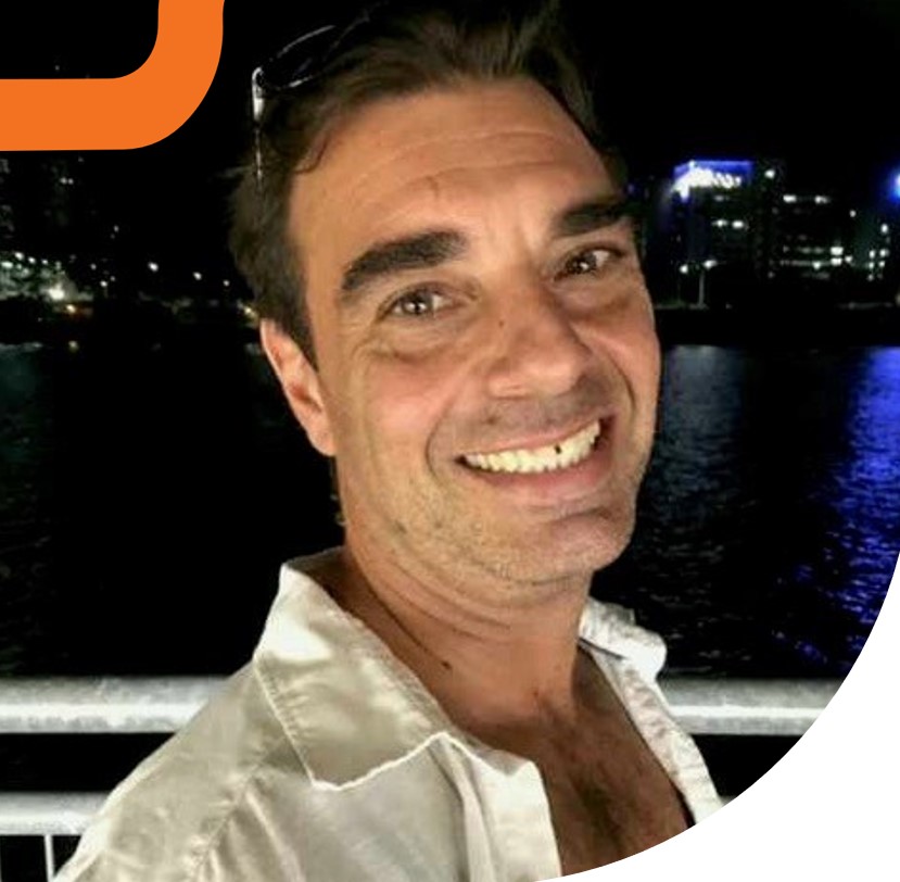Smiling man standing on bridge at night