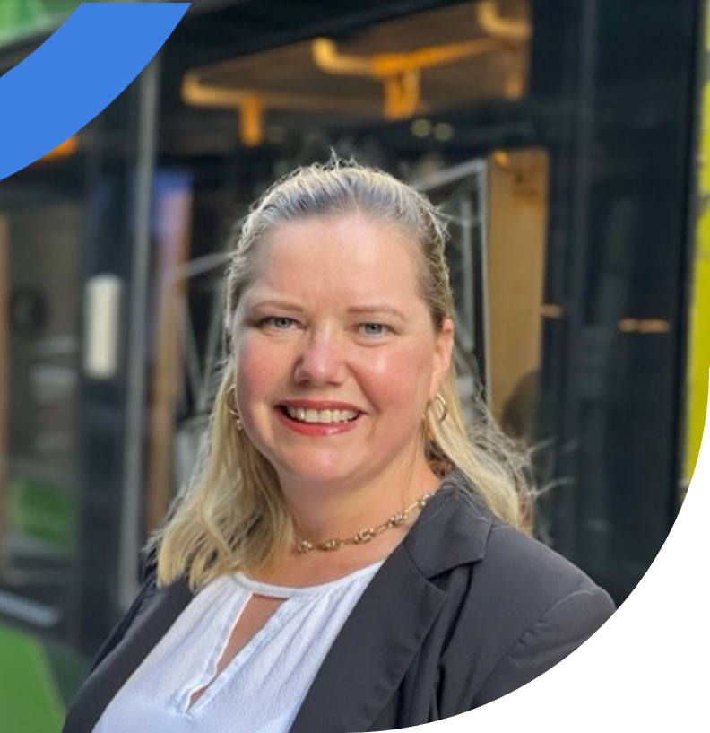 Smiling female engineer in front of a train