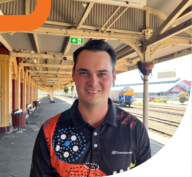 Man standing on country rail platform.