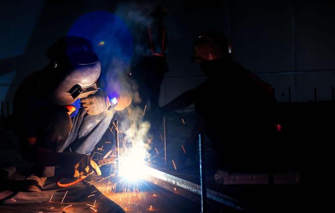 person wielding with sparks flying