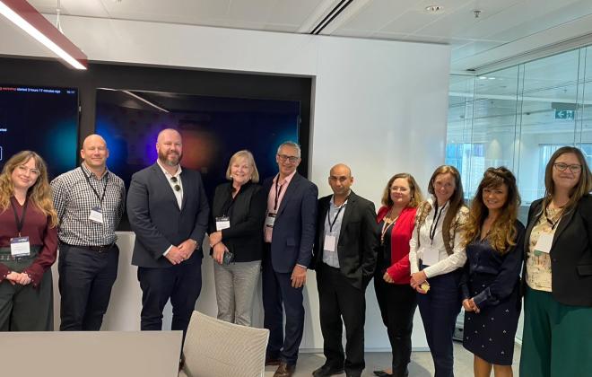 Group of men and women posing after a meeting