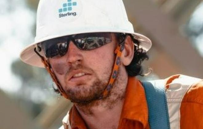 Man in Sterling hard hat on rail bridge 