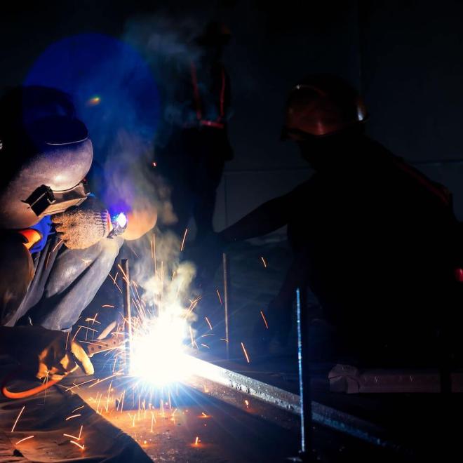 person wielding with sparks flying