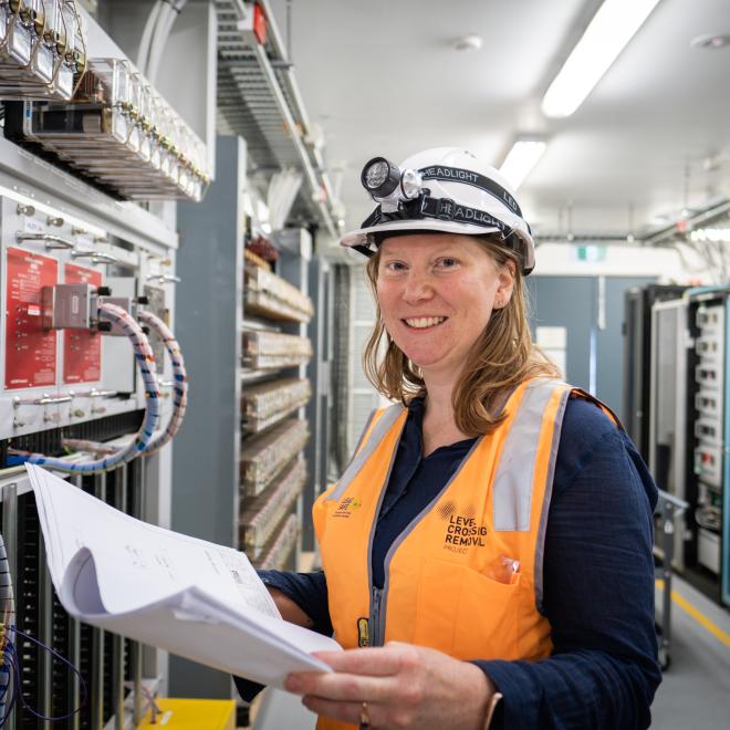 Woman examining circuit board