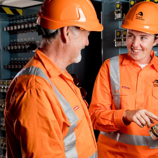Woman showing man signalling equipment